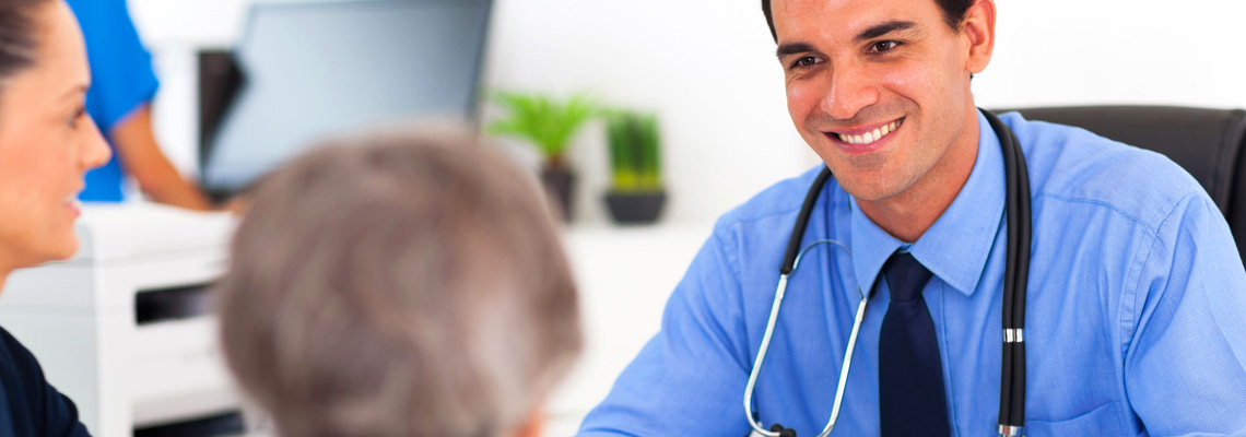 medical doctor consulting senior patient in office